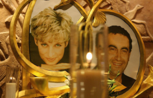 Colored photo of a picture of Princess Diana and of Dodi Al-Fayed with a candle in front of them