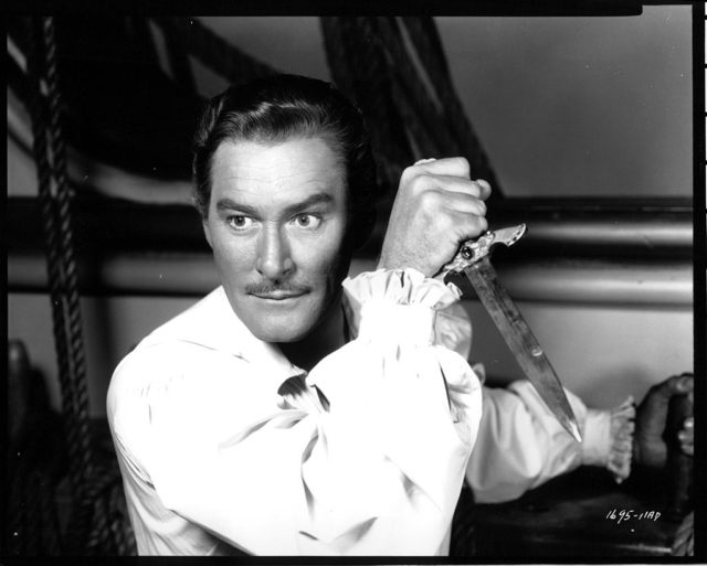 Errol Flynn holds a dagger 