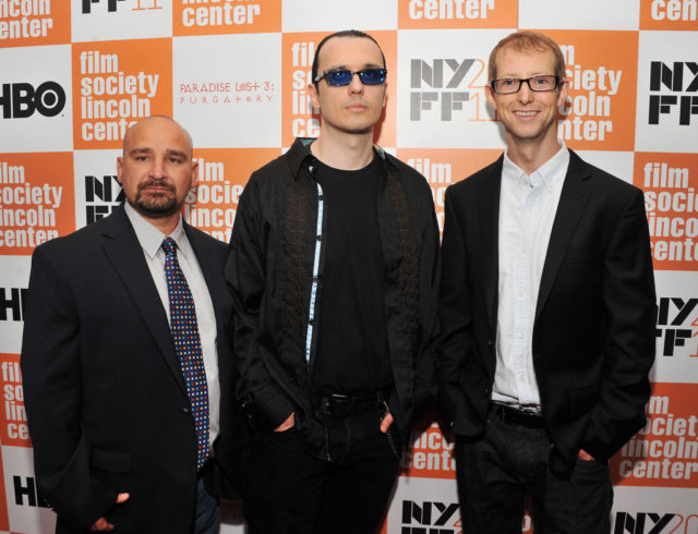 Colored photo of Jessie Misskelley, Damien Echols, and Jason Baldwin all wearing black clothing in front of an orange and white background.