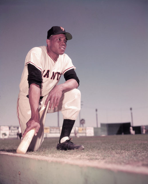 Willie Mays kneels on the field