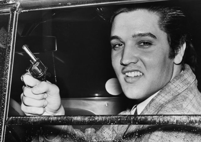 Elvis holding a toy gun