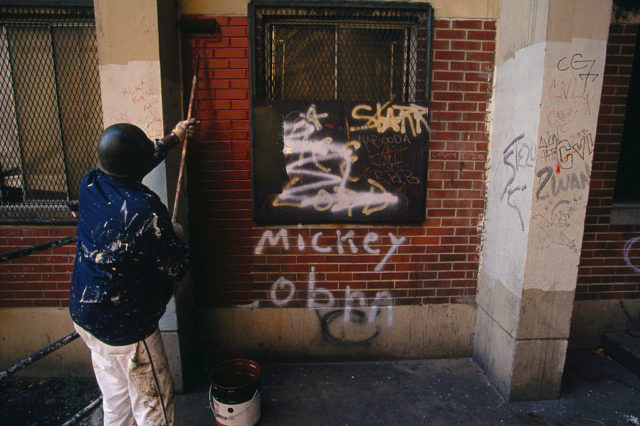 A worker paints over graffiti at Cabrini-Green