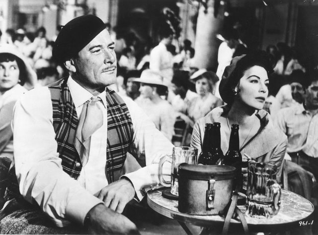 Errol Flynn and Ava Gardner sit at a table drinking beer in 'The Sun Also Rises'
