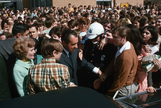 Richard Nixon wades through a crowd 