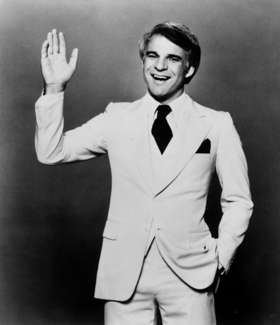 Steve Martin smiling and waving