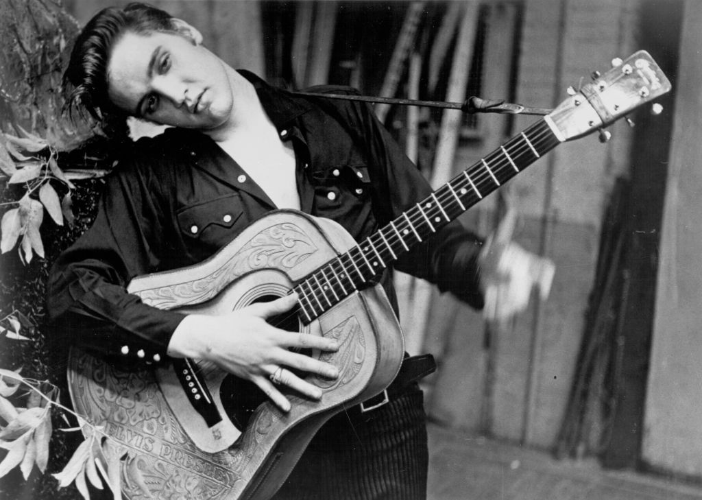 Elvis posing with a guitar