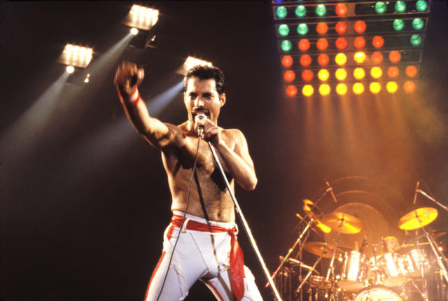 Freddie Mercury performing with Queen on stage