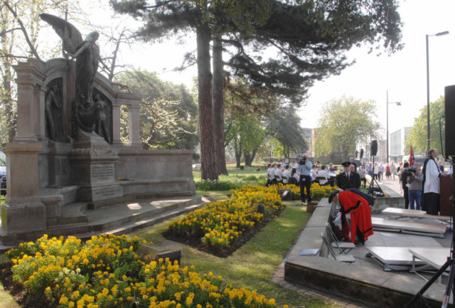 People lay flowers at a Titanic memorial