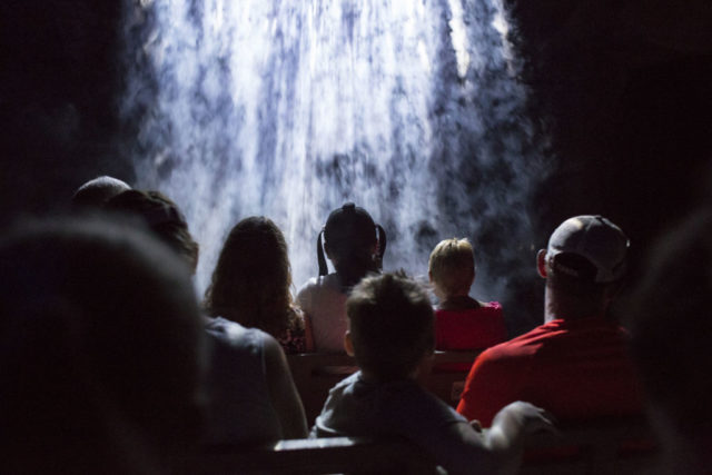 Guests look up at waterfall