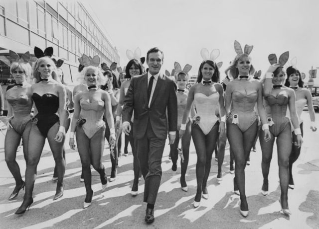Hugh Hefner flanked by Playboy Bunnies