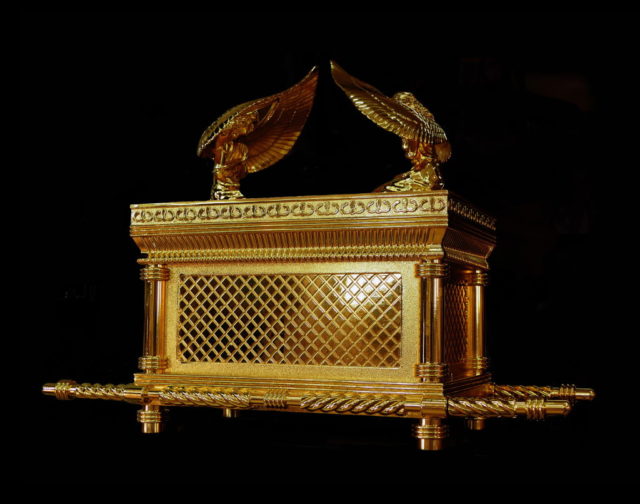 Coloured photo of a replica of the Ark of the Covenant, a cold box with two birds on top.