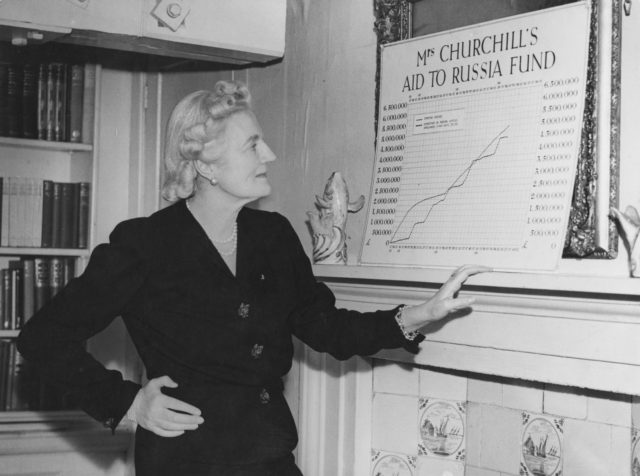 Clementine Churchill stands near a poster