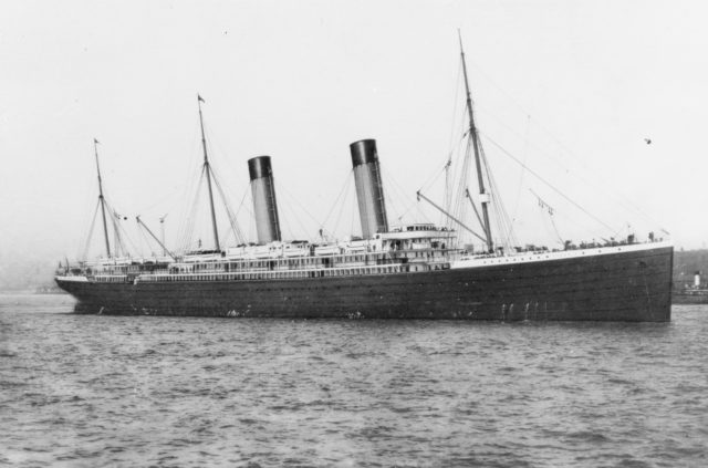 Black and white photo of the RMS Oceanic, a large ship sailing in the water.