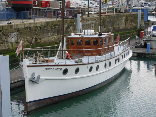 Coloured photo of the Sundowner yacht that Charles Lightoller sailed to Dunkirk. It is a white boat with a brown wood cabin and circular windows on the side. 