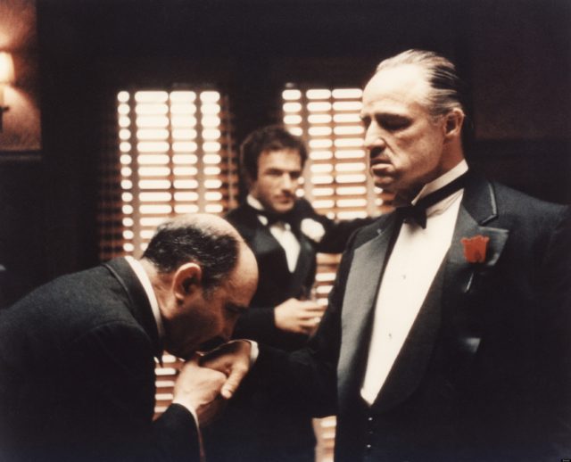 A man kisses Vito Corleone's hand in 'The Godfather'