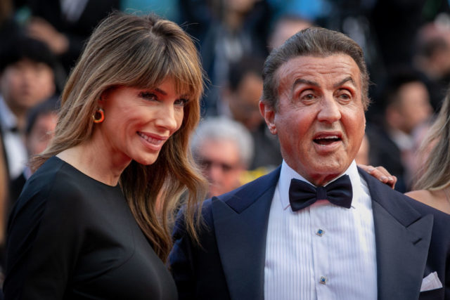 Jennifer Flavin Stallone and Sylvester Stallone wearing fancy dress clothing on the red carpet.