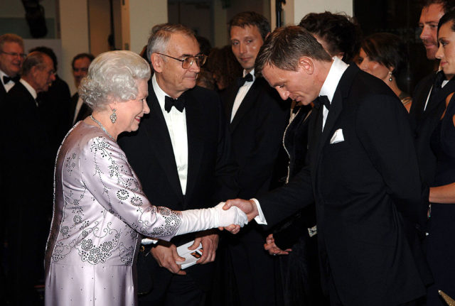 Queen Elizabeth II shaking hands with Daniel Craig