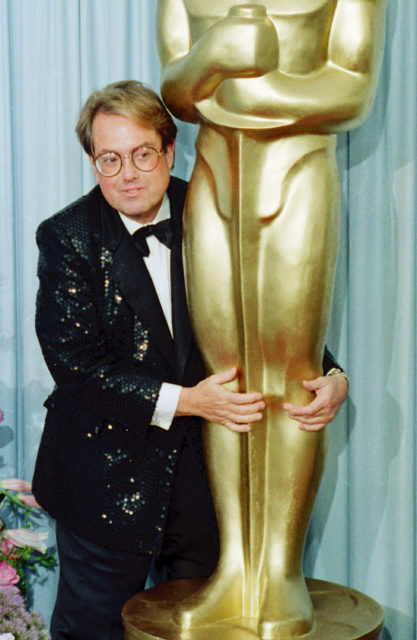Allan Carr hugging a giant Oscar