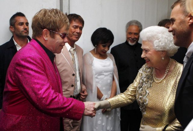 Elton John shaking Queen Elizabeth II's hand