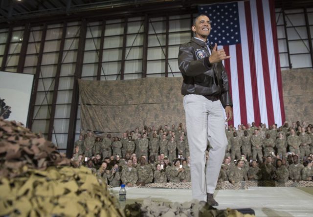Barack Obama throws a "shaka" while visiting American troops
