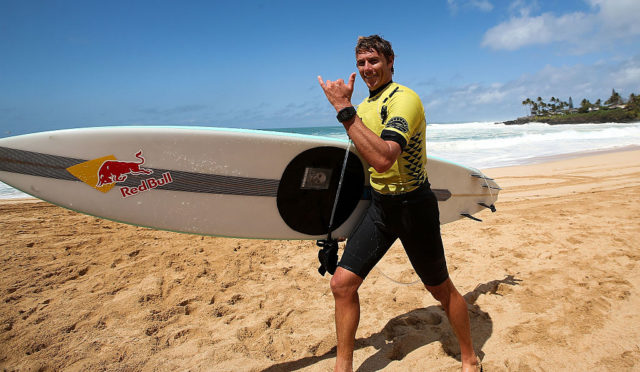 Surfer Ian Walsh holds up a shaka after surfing