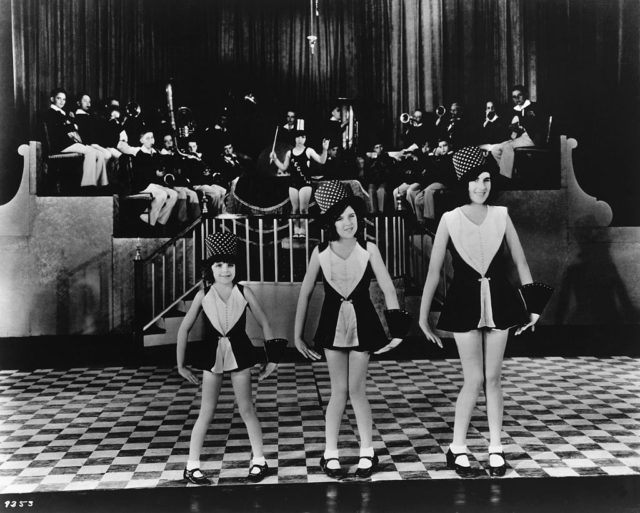 Judy Garland and her sisters, Mary Jane and Virginia Gumm, performing on stage
