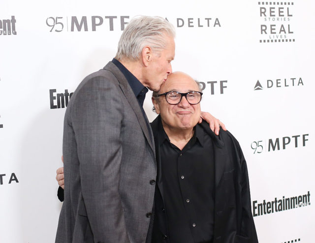 Michael Douglas kissing the top of Danny DeVito's head