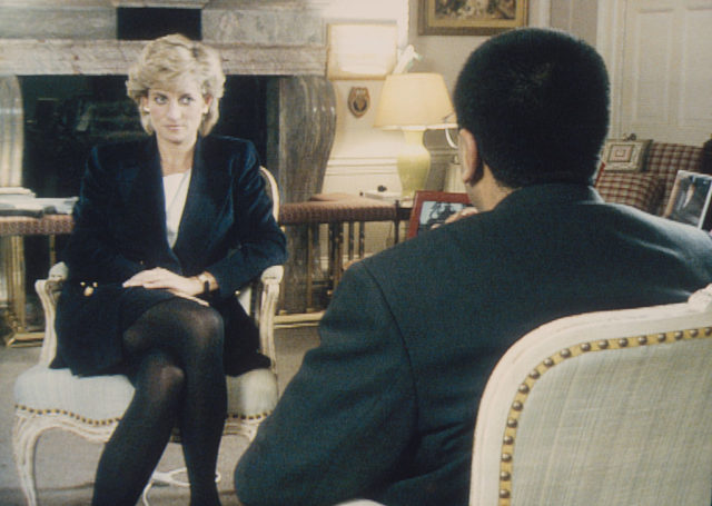 Colored photo of Diana sitting down in a black suit jacket during an interview.