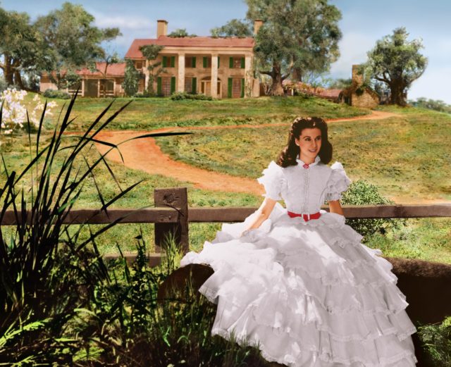 Vivien Leigh as Scarlett O'Hara in front of a large plantation estate