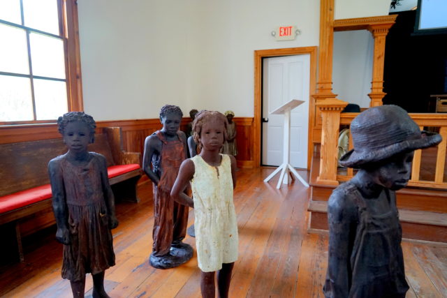 Iron statues of African American children at the Whitney Plantation