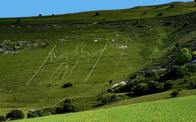 Side of a green hill with the Long Man of Wilmington looking for ley lines