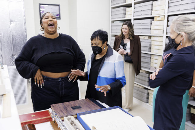 Lizzo and Carla Hayden looking at flutes