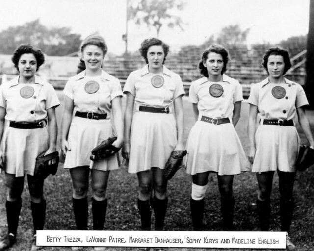 Five members of the All-American Girls Professional Baseball League (AABPBL) standing in uniform
