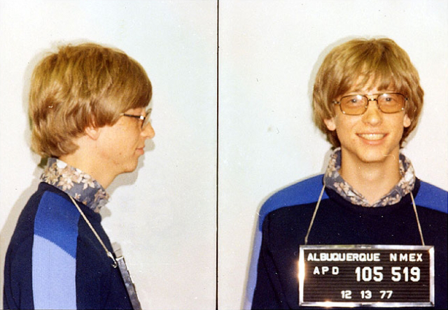 Side by side mug shot of Bill Gates in a blue sweater.