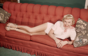 Doris Day poses on a couch, circa 1945