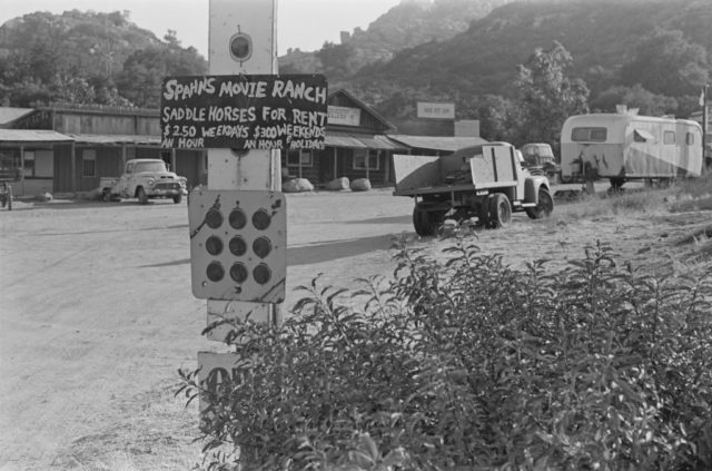 Black and white photo of a ranch where the Manson family live with a building and a truck in the frame.