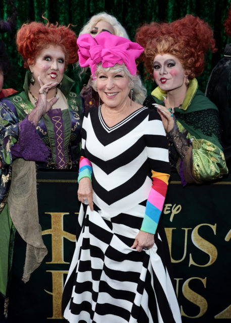 Bette Midler in. striped dress and pink head wrap