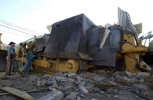 Large bulldozer with metal sheets welded to the outside.