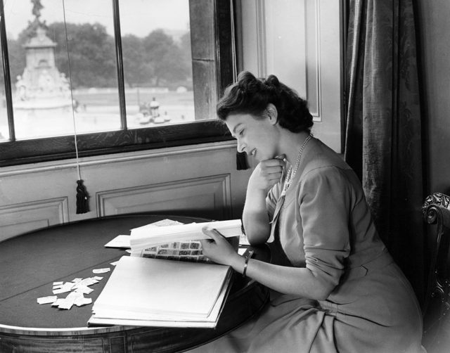 Princess Elizabeth looking at her stamp collection