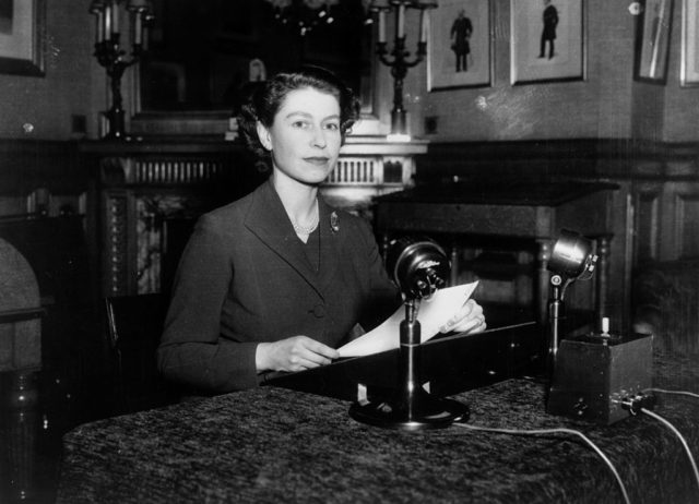 Queen Elizabeth II reads into a microphone