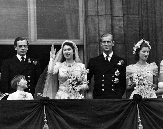 Princess Elizabeth and Prince Philip wave to the crowds from the balcony at Buckingham Palace on their wedding day