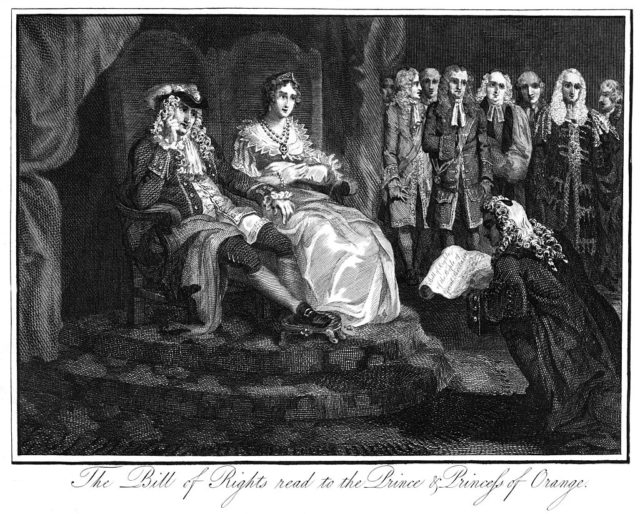 Man in a black robe and white wig kneels down while reading the Bill of Rights to the Prince and Princess of Orange who sit on a platform in two thrones.