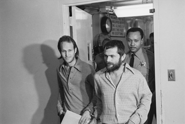 Steve Grogan and Bruce Davis, Manson family members, handcuffed together as they walk through the courthouse. 