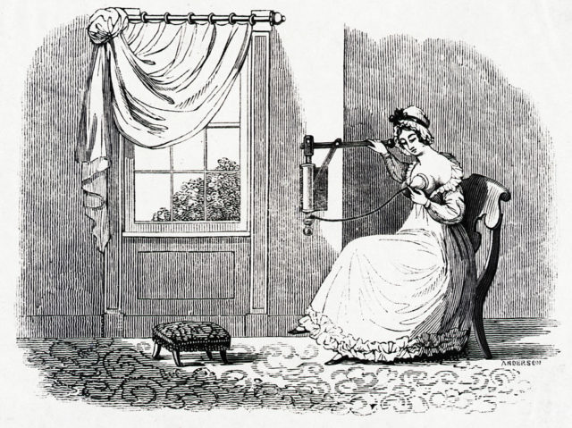 A 19th century woman uses a manual breast pump 