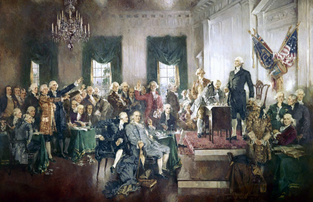 Group of men gather to sign the US Constitution.