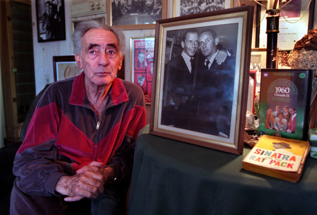 Joey Bishop with a photo of him and Sinatra