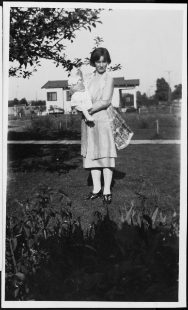 Gladys Baker standing with an infant Marilyn Monroe in her arms