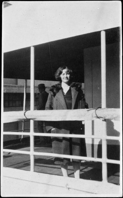 Gladys Baker standing behind a balcony