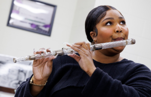 Lizzo playing the crystal flute