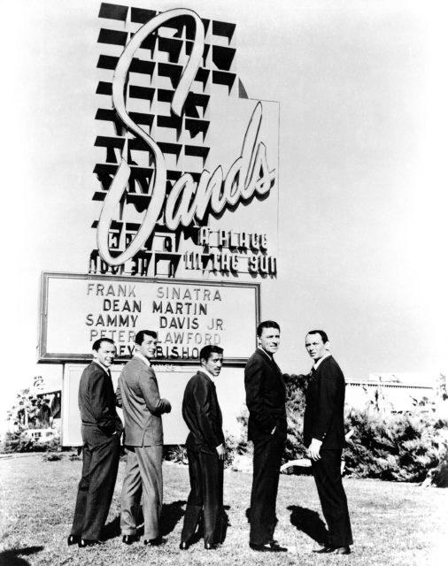 The Rat Pack poses at the sign for the Sands Hotel and Casino in Las Vegas